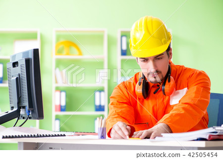 Construction supervisor planning new project in office 42505454