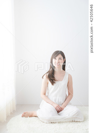 A woman in a white dress A woman in a white dress 42505646