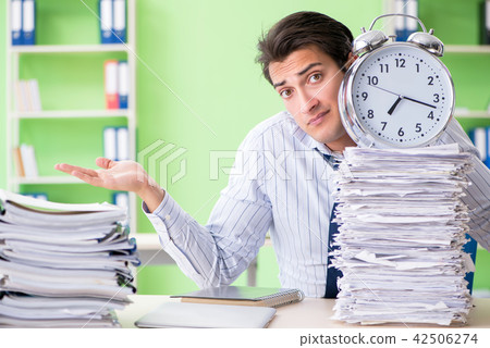 Businessman having problems with paperwork and workload Businessman having problems with paperwork and workload 42506274