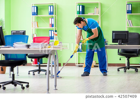Male handsome professional cleaner doing mopping in the office 42507409