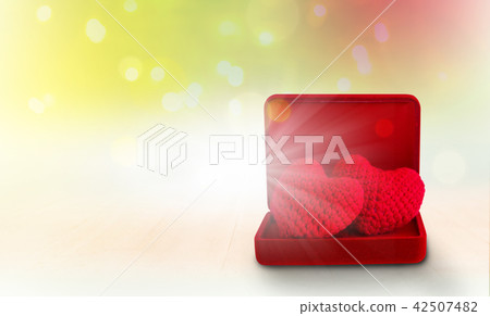 red heart in red box on wooden floor 42507482