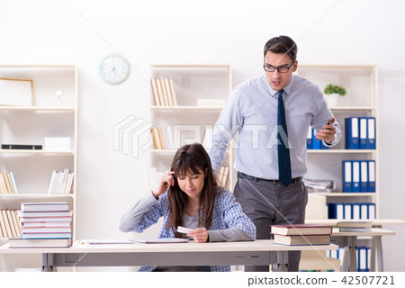 Male lecturer giving lecture to female student Male lecturer giving lecture to female student 42507721
