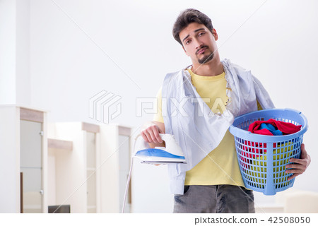 Handsome man husband doing clothing ironing at home Handsome man husband doing clothing ironing at home 42508050