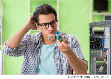 Computer engineer repairing broken desktop Computer engineer repairing broken desktop 42510623