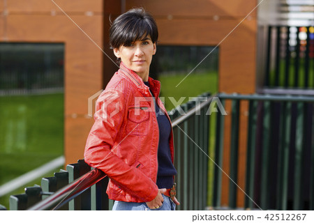 Mid aged woman wearing casual clothes outdoors Mid aged woman wearing casual clothes outdoors 42512267