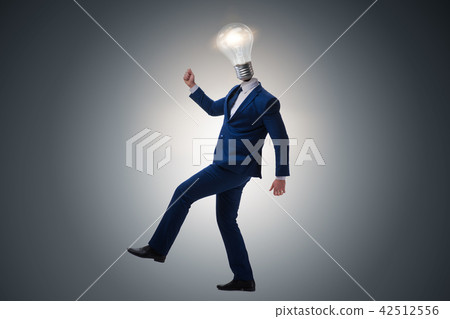 Businessman in bright idea concept with lightbulb head 42512556