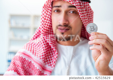 Arab man with bitcoin in cryptocurrency mining concept 42515629