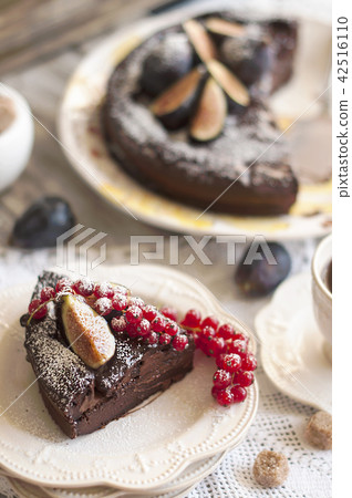 chocolate cake with berries and coffee, decor of red currants and figs. Autumn fruits and pastries 42516110