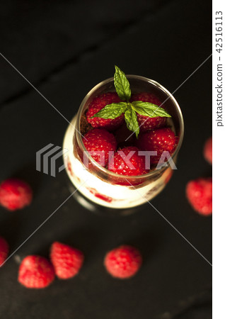 Tiramisu with raspberry in glasses on grey background. Three portion. Italian dessert 42516113