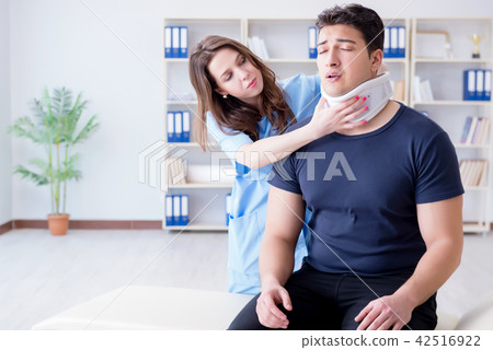 Man with neck injury visiting doctor for check-up 42516922