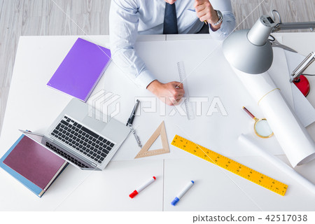 Engineer working on new project drawings Engineer working on new project drawings 42517038