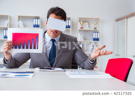 Businessman with virtual reality glasses in the office Businessman with virtual reality glasses in the office 42517385