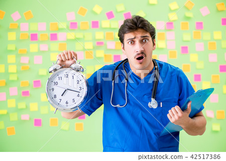 Young doctor with many reminders and urgent work 42517386
