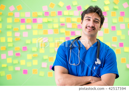 Young doctor with many reminders and urgent work 42517394