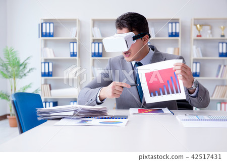 Businessman with virtual reality glasses in the office Businessman with virtual reality glasses in the office 42517431