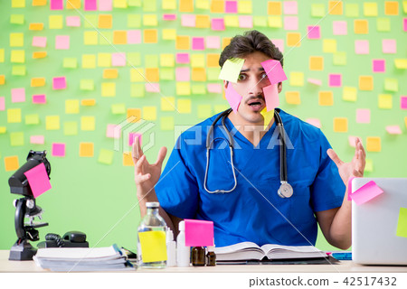 Young doctor with many reminders and urgent work Young doctor with many reminders and urgent work 42517432