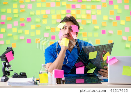 Young doctor with many reminders and urgent work 42517435