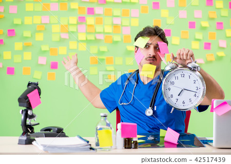 Young doctor with many reminders and urgent work Young doctor with many reminders and urgent work 42517439