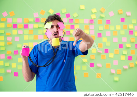 Young doctor with many reminders and urgent work Young doctor with many reminders and urgent work 42517440