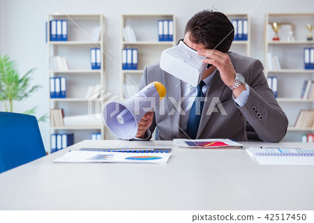Businessman with virtual reality glasses in the office 42517450