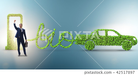 Businessman with car powered with biofuel Businessman with car powered with biofuel 42517897