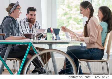 Four proficient freelancers and independent contractors co-working Four proficient freelancers and independent contractors co-working 42518576