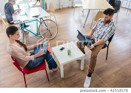 Dedicated young woman editing a document in a modern office space Dedicated young woman editing a document in a modern office space 42518578