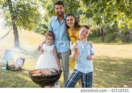 Portrait of happy family with two children standing outdoors 42518581