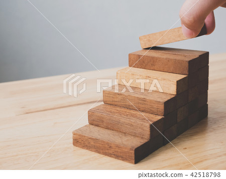 Hand arranging wood block stacking as step stair Hand arranging wood block stacking as step stair 42518798