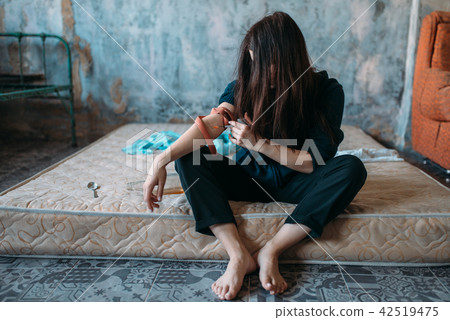 Drug addict with a syringe doing an injection dose Drug addict with a syringe doing an injection dose 42519475