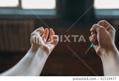 Junkie hands with syringe, drug addiction concept 42519477