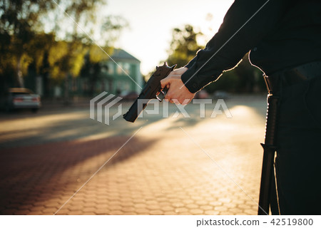Male cop in uniform with gun in hands Male cop in uniform with gun in hands 42519800