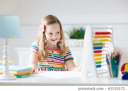 Child with abacus doing homework after school. 42520172