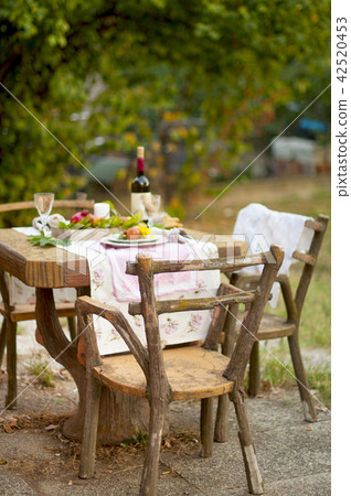 Lunch is romantic in autumn garden, atmosphere of holiday and coziness. Autumnal dinner in the open 42520453