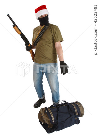 robber in a cap of Santa Claus with shotgun 42522483