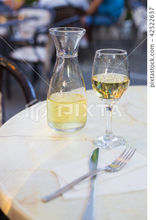 White wine in a liter bottle on a table in a cafe White wine in a liter bottle on a table in a cafe 42522637