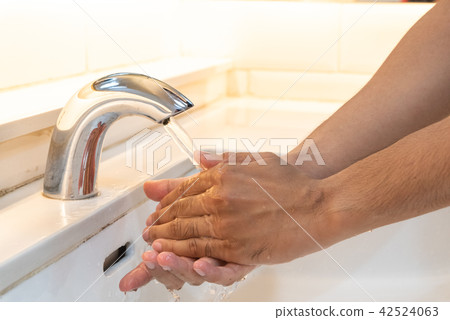 Closeup man washing hands with soap 42524063