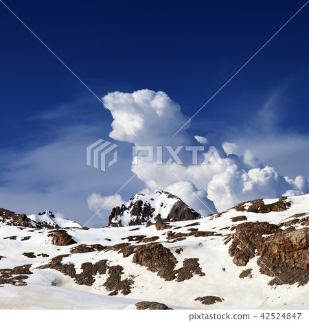 Snowy rocks and sky with clouds at nice day Snowy rocks and sky with clouds at nice day 42524847