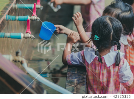 Students drinking water from the faucet Students drinking water from the faucet 42525335