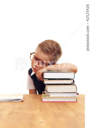 Funny cute little boy posing at school desk Funny cute little boy posing at school desk 42525426