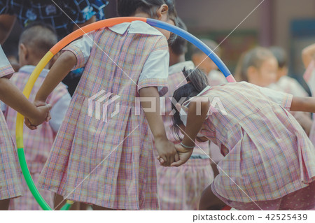 Young Kids exercise with hoola hoop Young Kids exercise with hoola hoop 42525439