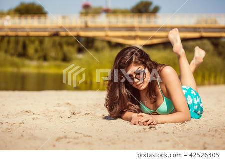 hot sexy brunette in a turquoise swimsuit on the beach 42526305