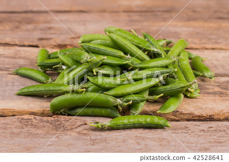 Heap of green peas on wood. Heap of green peas on wood. 42528641