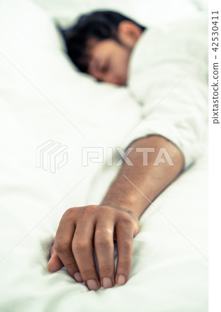 Young man sleep in bed in the bedroom. Young man sleep in bed in the bedroom. 42530411