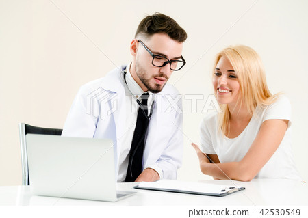 Male Doctor and Female Patient in Hospital Office 42530549