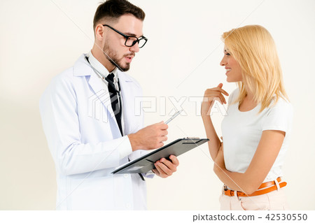 Male Doctor and Female Patient in Hospital Office 42530550