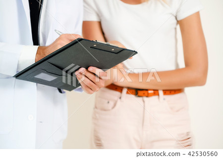 Male Doctor and Female Patient in Hospital Office Male Doctor and Female Patient in Hospital Office 42530560