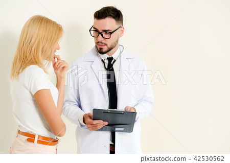 Male Doctor and Female Patient in Hospital Office Male Doctor and Female Patient in Hospital Office 42530562