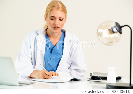 Doctor in hospital working on medical report. 42530618