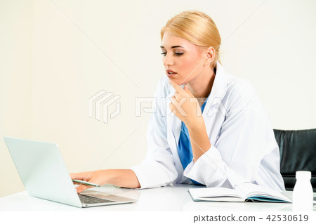 Doctor in hospital working on medical report. 42530619